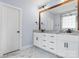 Bathroom with large mirror over double vanity and white marble floors at 3622 46Th Ne Ave, Hickory, NC 28601