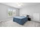 This bedroom features a ceiling fan, large window, and soft, neutral colored carpet at 3622 46Th Ne Ave, Hickory, NC 28601