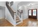 Elegant entryway featuring hardwood floors, staircase with wrought iron railings, and a beautiful front door at 3622 46Th Ne Ave, Hickory, NC 28601