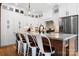 Gourmet kitchen island with marble countertop, seating, and modern fixtures, complemented by white cabinetry at 3622 46Th Ne Ave, Hickory, NC 28601