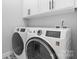 Laundry room showcasing modern washer and dryer units and sleek tile flooring at 3622 46Th Ne Ave, Hickory, NC 28601