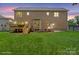 Home's backyard features a lush lawn, and a deck with steps leading down to the yard at 4015 Randolph Rd, Charlotte, NC 28211