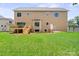A large, green backyard with a wooden deck and stairs attached to a two-story home at 4015 Randolph Rd, Charlotte, NC 28211