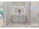 Bright bathroom featuring double vanity, illuminated mirror and glass shower at 4015 Randolph Rd, Charlotte, NC 28211