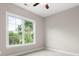 Bright bedroom features a ceiling fan and large windows offering lots of natural light and outdoor views at 4015 Randolph Rd, Charlotte, NC 28211
