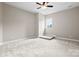 This bedroom is spacious and bright, with a plush carpet, neutral walls, and a window at 4015 Randolph Rd, Charlotte, NC 28211