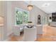 Sunlit breakfast nook features a modern chandelier, large window, and stylish seating at 4015 Randolph Rd, Charlotte, NC 28211