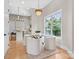 Cozy breakfast nook with a round table, stylish chandelier, and a view of the outdoors at 4015 Randolph Rd, Charlotte, NC 28211