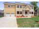 Inviting two-story home showcasing a spacious two-car garage, brick and siding details, and a lush front lawn at 4015 Randolph Rd, Charlotte, NC 28211