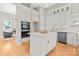 Bright kitchen featuring a central island with seating, stainless steel appliances, and abundant cabinet space at 4015 Randolph Rd, Charlotte, NC 28211