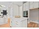 Bright kitchen features a marble island with gold accents, built-in oven, and white cabinetry at 4015 Randolph Rd, Charlotte, NC 28211