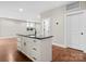 Kitchen features black countertops, white cabinets and hardware and hardwood flooring at 4015 Randolph Rd, Charlotte, NC 28211