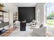 Contemporary office space with a black accent wall, neutral furniture, and ample natural light from a window at 4015 Randolph Rd, Charlotte, NC 28211