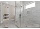 Luxurious bathroom with a glass-enclosed shower featuring marble-like tile at 4015 Randolph Rd, Charlotte, NC 28211