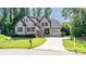 Charming brick two-story home with manicured lawn and mature trees, featuring a long driveway and welcoming front porch at 4017 Halyard Dr, Denver, NC 28037