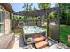 Outdoor hot tub area with a wooden pergola, privacy screen, and surrounding green lawn at 4017 Halyard Dr, Denver, NC 28037