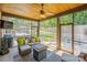 Cozy screened porch with seating, a ceiling fan, and views of the landscaped backyard with a hot tub at 4017 Halyard Dr, Denver, NC 28037