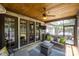 Relaxing screened porch featuring a comfortable seating area, ceiling fan, and access to a patio with a hot tub at 4017 Halyard Dr, Denver, NC 28037