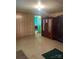 Bedroom view with an armoire showing a glimpse of a bright green adjacent room at 408 Moose St, Albemarle, NC 28001