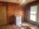 Wood paneled room with linoleum flooring, a vintage washing machine, and natural light at 408 Moose St, Albemarle, NC 28001