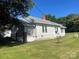 The back of the home shows white siding, grey roof, lattice enclosed porch, and green lawn at 408 Moose St, Albemarle, NC 28001