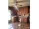 Kitchen with wood cabinets, linoleum flooring, and a window with blinds at 408 Moose St, Albemarle, NC 28001
