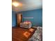 Cozy living room with hardwood floors, a brick fireplace, and comfortable seating at 408 Moose St, Albemarle, NC 28001