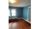 Spacious living room with hardwood floors, natural light, and vintage charm at 408 Moose St, Albemarle, NC 28001