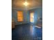 Bright living room featuring blue walls, vintage flooring, and natural light at 408 Moose St, Albemarle, NC 28001