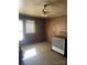 Cozy living room with wood paneled walls, a window unit, and vintage heater at 408 Moose St, Albemarle, NC 28001