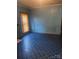 Living room with blue walls and patterned vinyl flooring bathed in sunlight at 408 Moose St, Albemarle, NC 28001