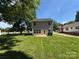 Backyard view of the two-story home highlighting the well-maintained lawn at 414 1St Avenue Se None, Hickory, NC 28602