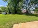 Large grassy backyard surrounded by mature trees, creating a private outdoor space at 414 1St Avenue Se None, Hickory, NC 28602