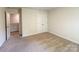 Bedroom featuring carpet, white walls, closet, and door to hallway at 414 1St Avenue Se None, Hickory, NC 28602