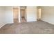 View of a bedroom with neutral walls and carpet, and doorways to the closet and hallway at 414 1St Avenue Se None, Hickory, NC 28602
