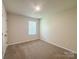 Bright bedroom has neutral carpet and walls, with a window providing natural light at 414 1St Avenue Se None, Hickory, NC 28602