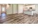 Spacious living area with view to the kitchen, stairs and wood-look flooring at 414 1St Avenue Se None, Hickory, NC 28602