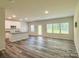 Open living room with a modern kitchen, plenty of natural light, and stylish flooring at 414 1St Avenue Se None, Hickory, NC 28602