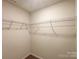 Spacious walk-in closet with metal shelving and neutral carpet for organized storage space at 414 1St Avenue Se None, Hickory, NC 28602