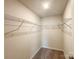 Well-organized walk-in closet with shelving and carpeted floor for efficient storage solutions at 414 1St Avenue Se None, Hickory, NC 28602