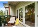 Cozy balcony seating area with a yellow Adirondack chair and cushioned bench, perfect for relaxing outdoors at 415 N Church St # 311, Charlotte, NC 28202