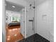 Modern bathroom with a glass-enclosed shower and black and white tile at 415 N Church St # 311, Charlotte, NC 28202