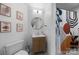 Modern bathroom featuring a stylish vanity, round mirror, and sleek shower with designer curtain at 415 N Church St # 311, Charlotte, NC 28202