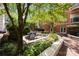 Beautiful courtyard with lush landscaping, a brick patio, and comfortable seating areas at 415 N Church St # 311, Charlotte, NC 28202