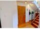 Welcoming entryway featuring a wood door, hardwood floors, and stairs with modern metal railings at 415 N Church St # 311, Charlotte, NC 28202