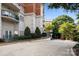 Well-maintained condo building with balconies, manicured landscaping, and mature trees at 415 N Church St # 311, Charlotte, NC 28202