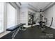Community fitness room with bench, mirrored wall, and exercise machine at 415 N Church St # 311, Charlotte, NC 28202