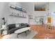 Open floor plan living room featuring a comfortable couch, modern decor, and views into the kitchen at 415 N Church St # 311, Charlotte, NC 28202