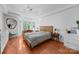 Serene primary bedroom with hardwood floors, a bay window desk, and elegant decor at 415 N Church St # 311, Charlotte, NC 28202