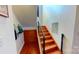 Bright staircase with wooden steps, modern metal railings, and a skylight at the top at 415 N Church St # 311, Charlotte, NC 28202